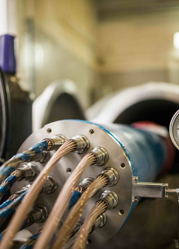 Set of high voltage cables with barometer A set of high voltage cables in common nozzle worn on iron drum with barometer connected to it